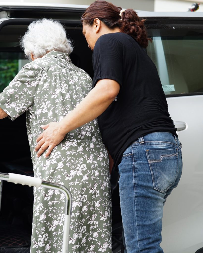 caregiver-help-asian-elderly-woman-disability-patient-get-her-car-medical-concept (Large)