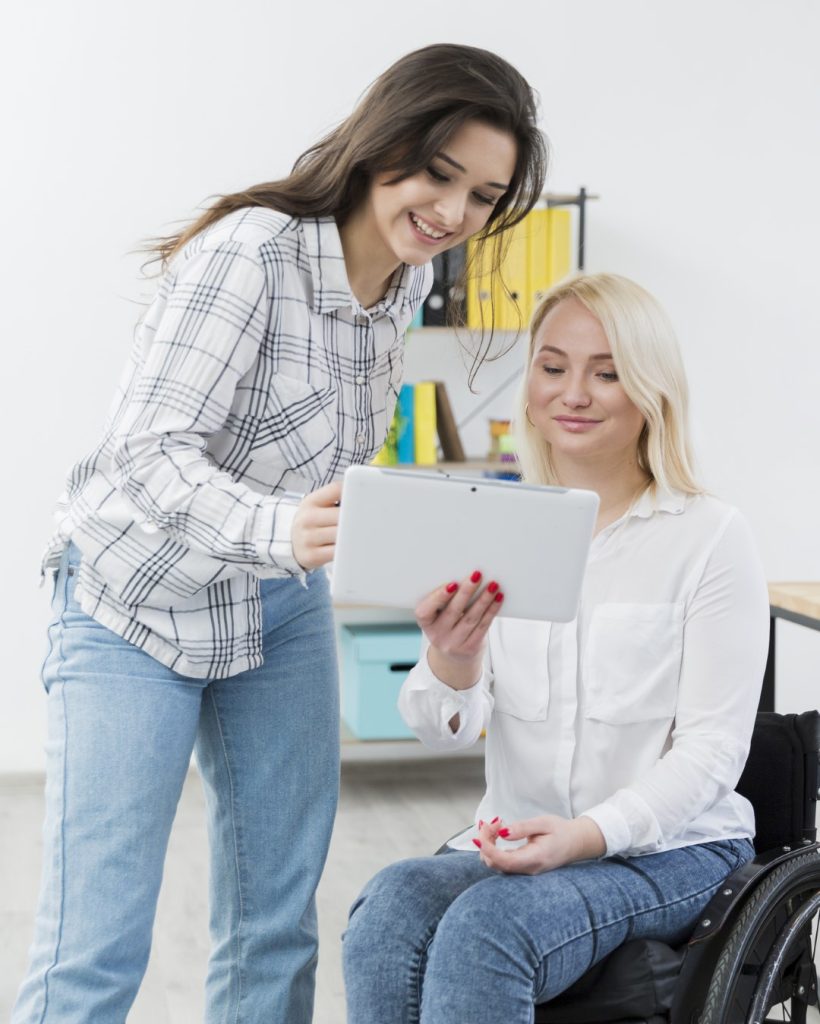 front-view-woman-wheelchair-holding-tablet (Large)