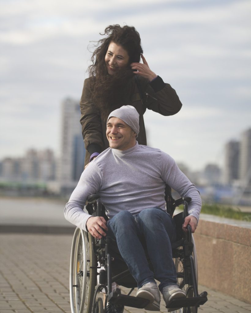 portrait-happy-couple-caring-woman-with-disabled-man-wheelchair (Large)