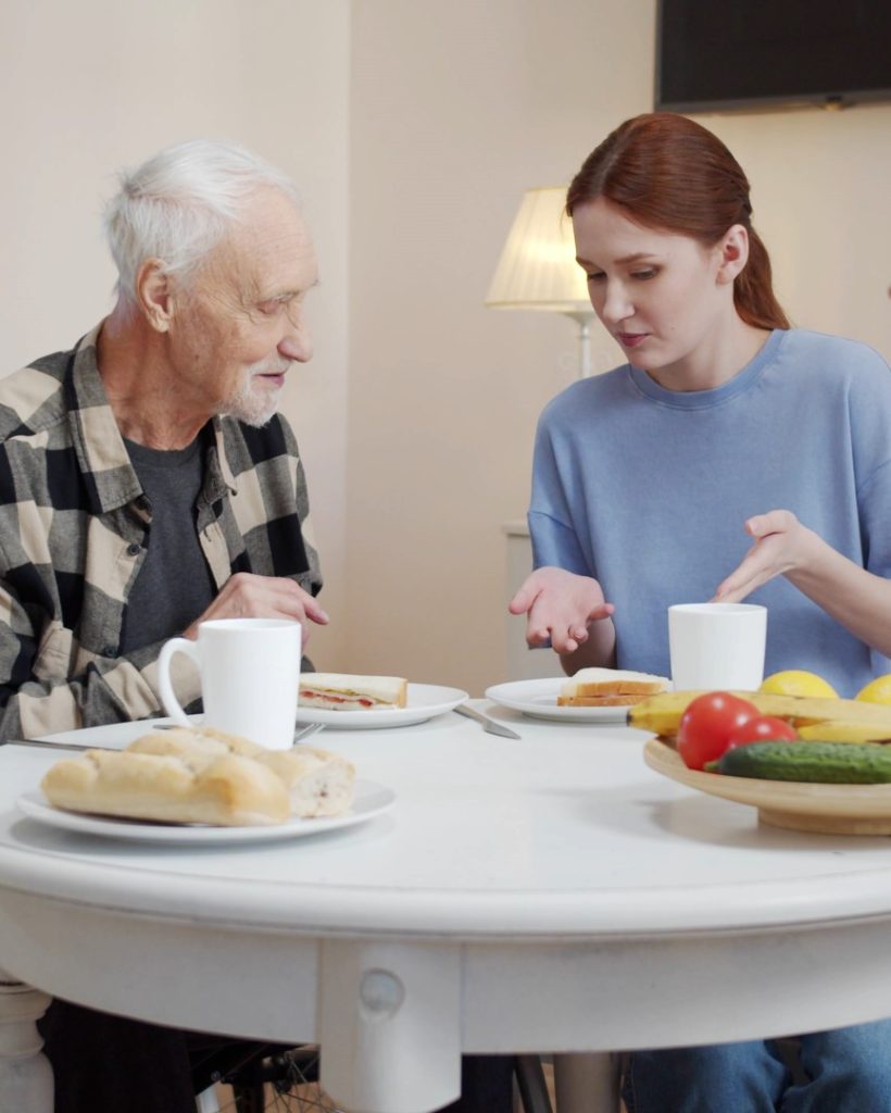 smiling-nurse-man-eating-food-nursing-home (Large)