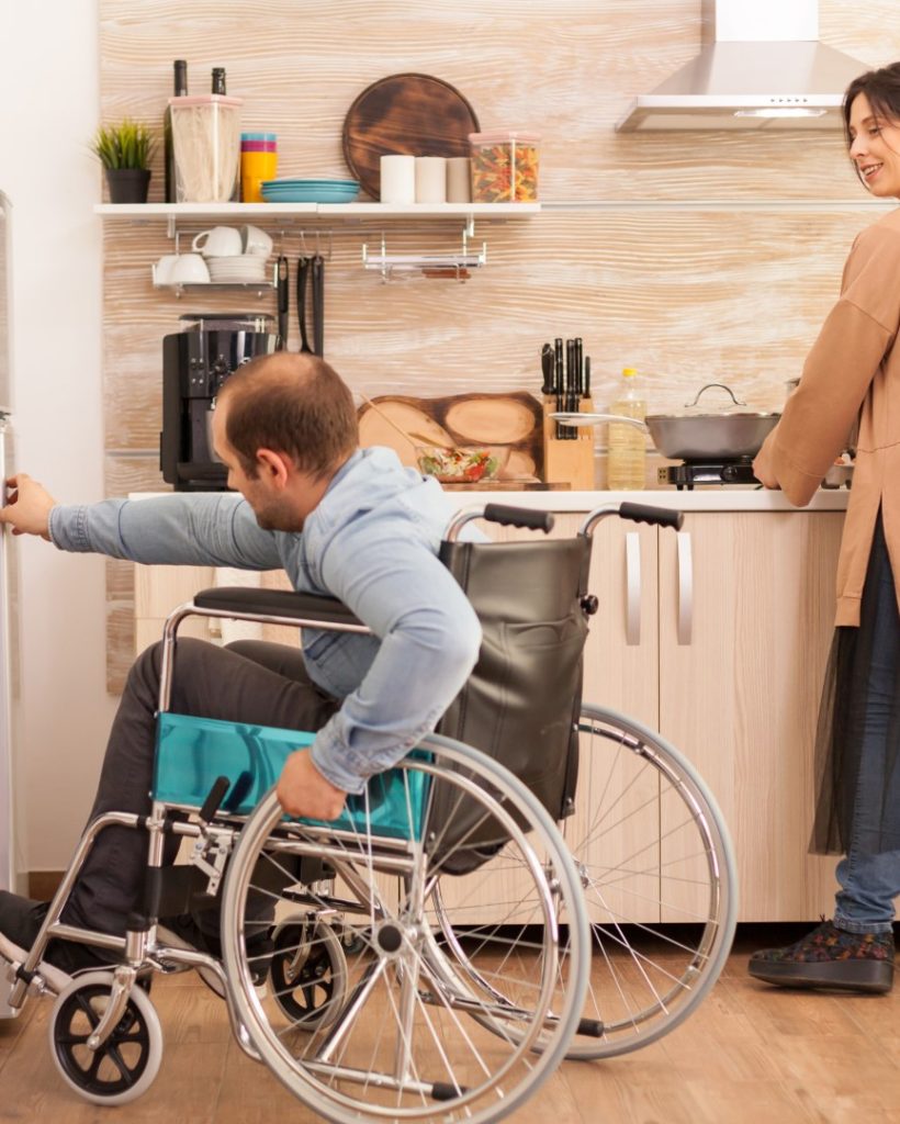woman-kitchen-looking-husband-with-walking-disability-trying-open-refrigerator-door-disabled-paralyzed-handicapped-man-with-walking-disability-integrating-after-accident (Large)